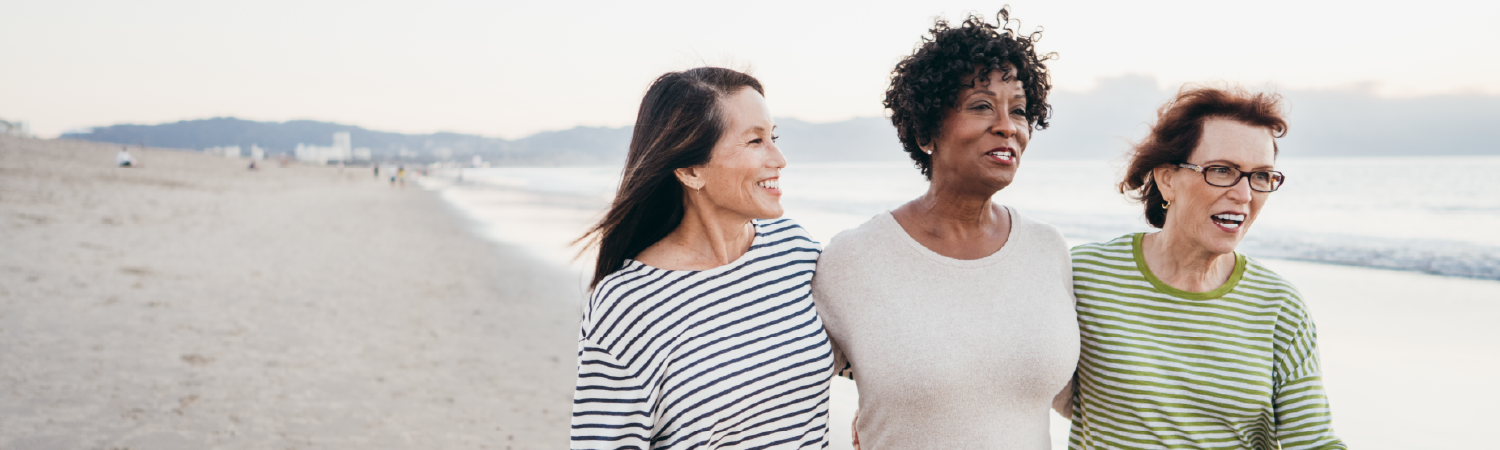 Women walking along the beach contemplating retirement